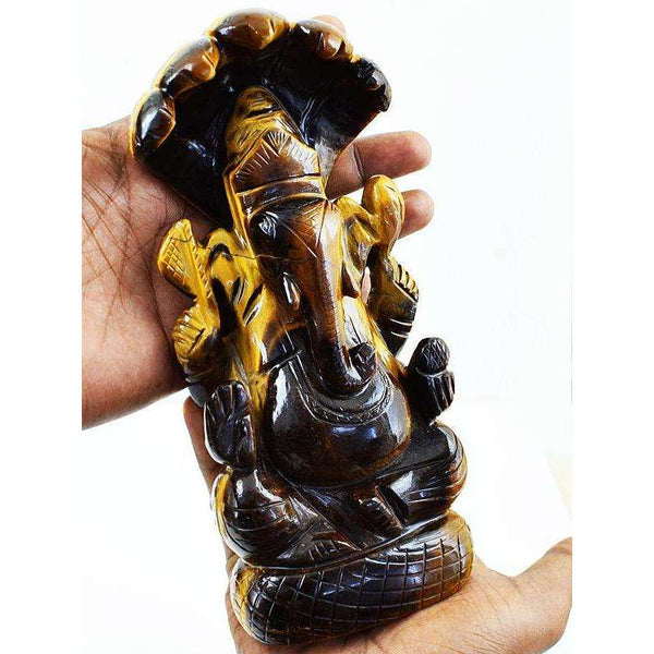 gemsmore:Premium Golden Tiger Eye Lord Ganesha Carved Idol With Snake At Back