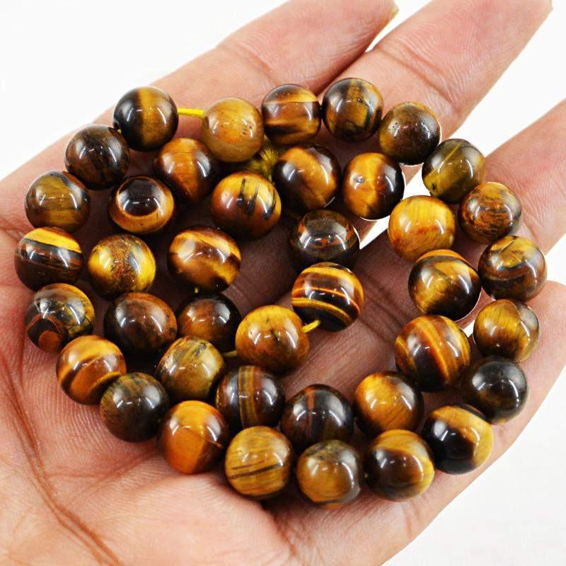 gemsmore:Round Shape Golden Tiger Eye Strand Natural Untreated Drilled Beads